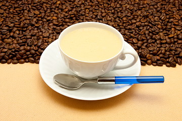 Image showing White cup of coffee and coffee beans