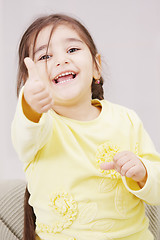 Image showing Girl in yellow with thumb up