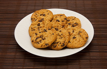 Image showing plate of cookies on dark brown background