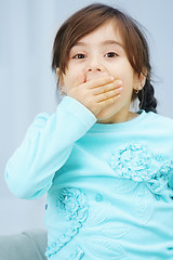 Image showing Little girl closes mouth