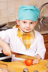 Image showing Little cook with knife and tomato