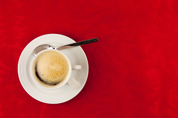 Image showing white cup of coffee  on red background