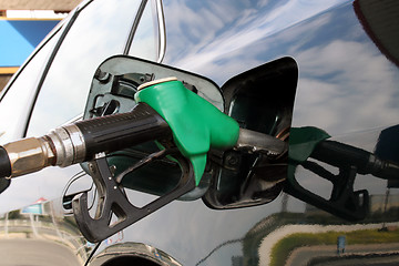 Image showing petrol pump filling car up with fuel