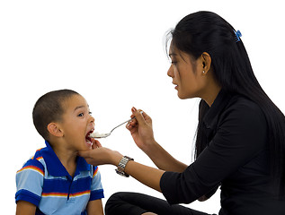 Image showing mother feeding her son