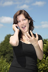Image showing Girl calling by cell phone gesturing w hand