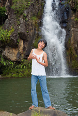 Image showing Boy singing at waterfall