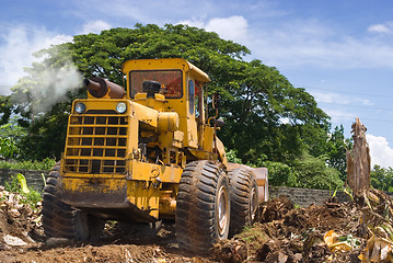 Image showing Worn bulldozer on tropical terrain