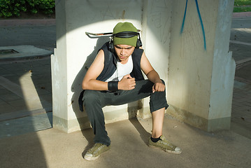 Image showing Young rapper man sitting