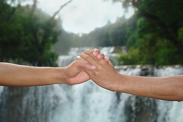 Image showing Handshake at waterfall