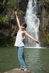 Image showing Boy balancing at waterfall