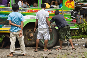 Image showing Filipino jeepney tire change