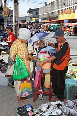 Image showing Asian street vendor w customer