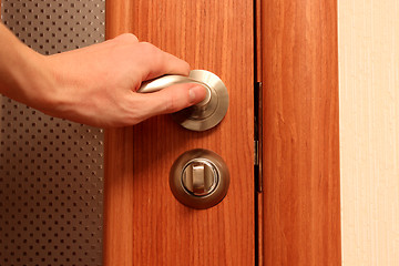 Image showing The hand opening a door