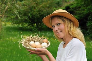 Image showing Young woman and Easter eggs