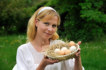 Image showing Young woman and Easter eggs