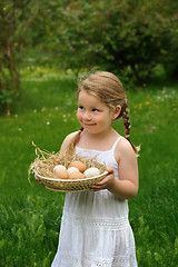 Image showing Little girl holding eggs