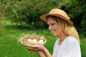 Image showing Young woman and Easter eggs