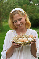 Image showing Young woman and Easter eggs