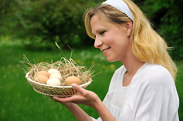 Image showing Young woman and Easter eggs