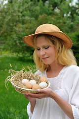 Image showing Young woman and Easter eggs