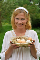 Image showing Young woman and Easter eggs