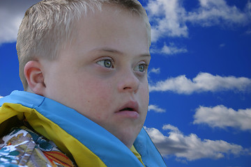 Image showing Down Syndrome Boy with Head in the Clouds