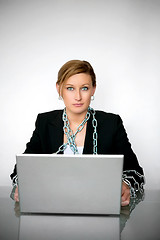 Image showing Beautiful young businesswoman chained to laptop