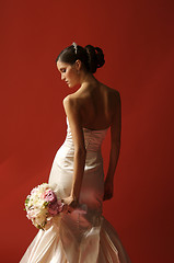 Image showing Bride Turned Toward Red Wall Looking Down