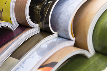 Image showing Stack of open magazines