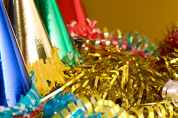 Image showing Holiday background with ribbons, serpentine and colored caps