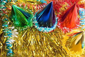 Image showing Holiday background with ribbons, serpentine and colored caps