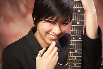 Image showing Multiethnic Girl Poses with Electric Guitar