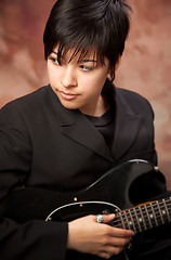 Image showing Multiethnic Girl Poses with Electric Guitar