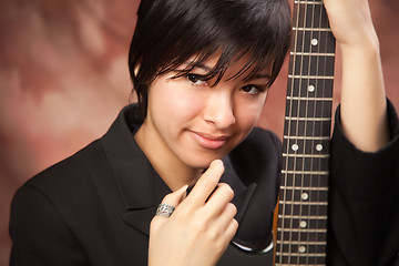 Image showing Multiethnic Girl Poses with Electric Guitar