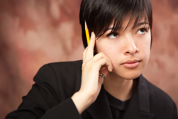 Image showing Multiethnic Girl Ponders While Holding Pencil