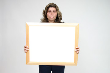 Image showing Young woman holding blank board