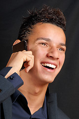 Image showing Smiling young business man with mobile