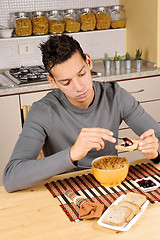 Image showing Young man having breakfast