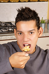 Image showing Young man eating cornflakes