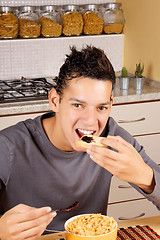 Image showing Young man having breakfast at home