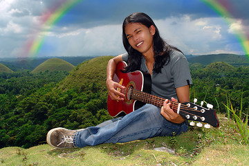 Image showing Smiling guitar player u rainbow