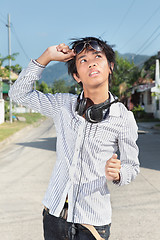 Image showing Asian teen looking at sun