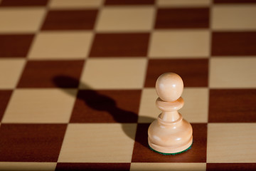 Image showing Chess piece - a white pawn on a chessboard.