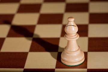 Image showing Chess piece - a white bishop on a chessboard.