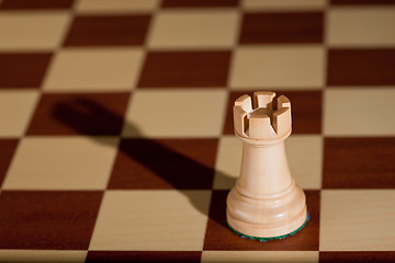 Image showing Chess piece - a white rook on a chessboard.