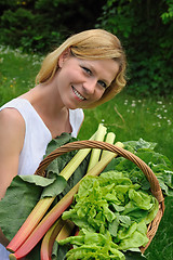 Image showing Young woman holding basket with vegetable