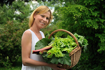 Image showing Young woman holding basket with vegetable