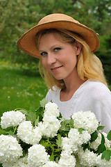 Image showing Young woman with snowballs