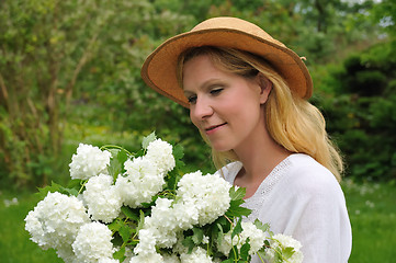 Image showing Young woman with snowballs