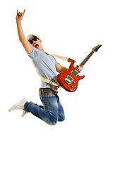 Image showing   Passionate guitarist jumps isolated on white